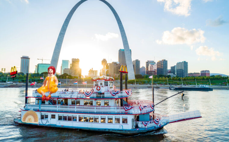 A crudely photoshopped image of the Tom Sawyer Riverboat in front of the Gateway Arch in St. Louis with McDonald's signage on the boat.